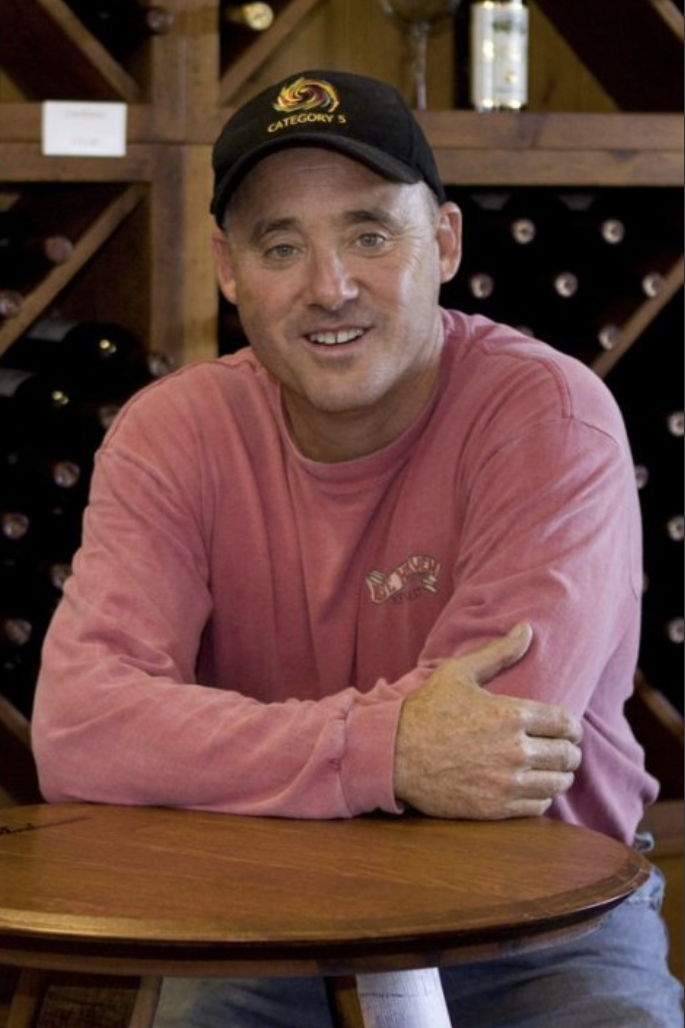 F&TJ’s Bloody Mary Mix Co-Founder Steve Shepard seated at a wooden bar, smiling.